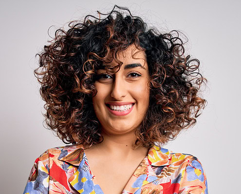 Young,Beautiful,Curly,Arab,Woman,Wearing,Floral,Colorful,Shirt,Standing