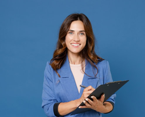 smiling woman holding a computer thinking about growth strategies for her b2b PR plan