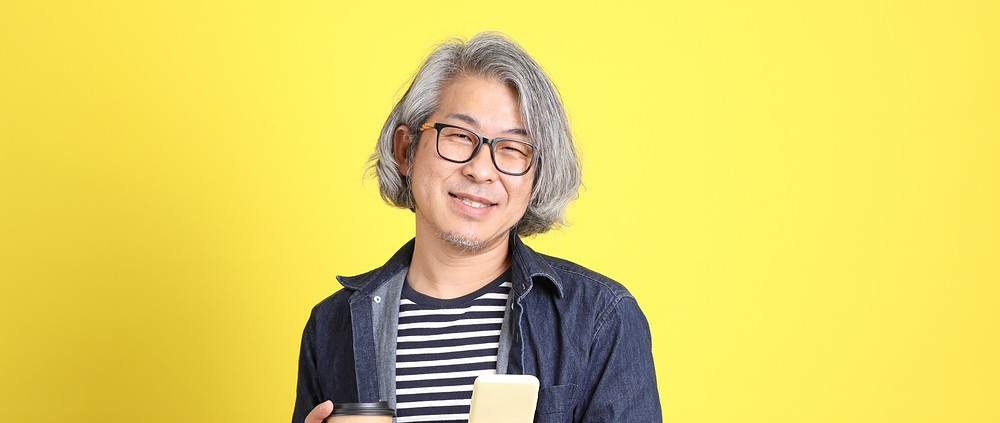 A man with a cup of coffee who is confident that he has avoided common pitfalls when hiring a PR agency