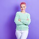 a woman with pink hair smiling because she has great digital PR for her consumer brand