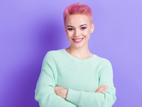 a woman with pink hair smiling because she has great digital PR for her consumer brand