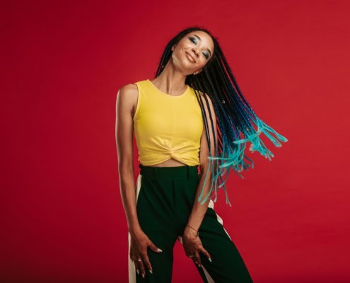 Stylish Confident Young African Woman smiling about the california cannabis industry