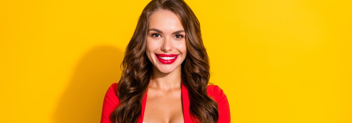 a confident female tech CEO in a bright red suit
