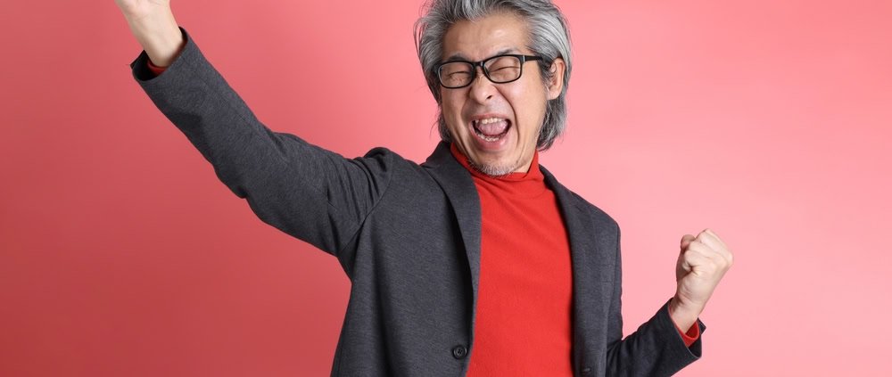 The,Asian,Man,Standing,On,The,Pink,Background.
