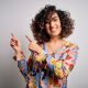 Beautiful woman with dark curly hair, pointing fingers at the title of the blog post about Tech Startups PR