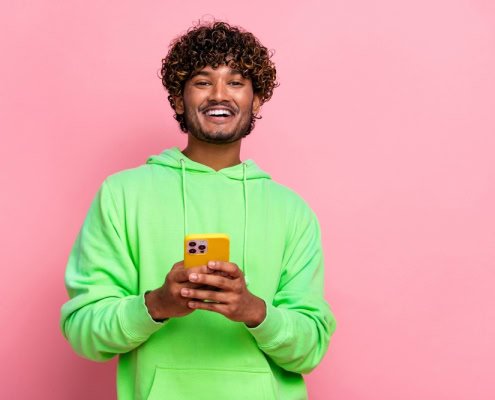 Portrait,Of,Positive,Young,Man,In,Green,Stylish,Sweatshirt,Holding