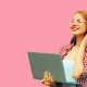 Picture of a modern young woman holding a laptop and listening to headphones