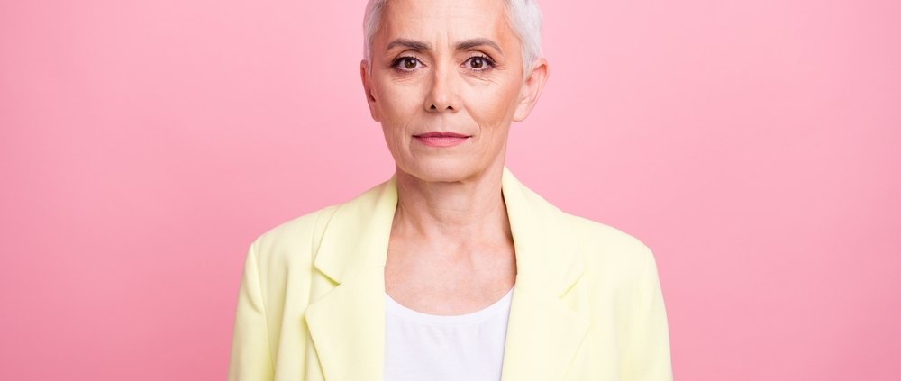 Portrait of an older woman in a blazer, looking serious