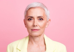Portrait of an older woman in a blazer, looking serious
