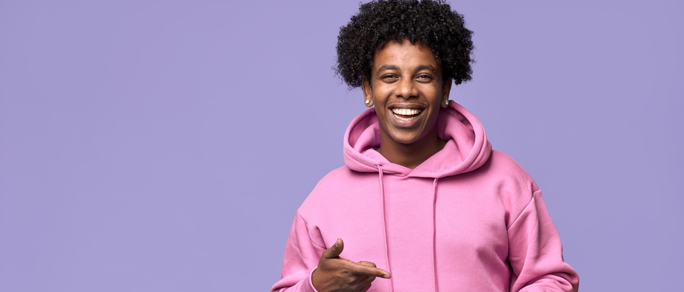 A happy, cool, African American Man in a pink sweatshirt