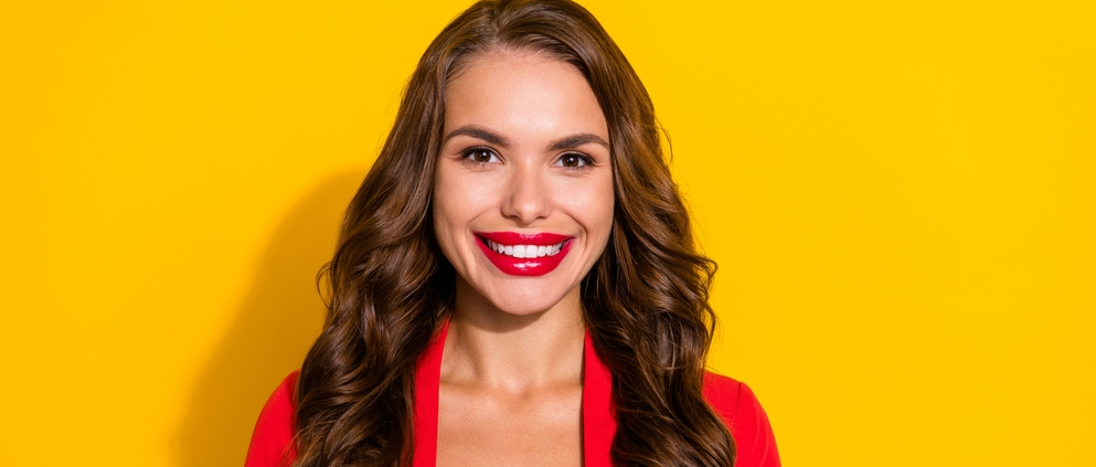Photo of a cheerful young woman smiling at the camera
