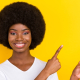 Photo of a happy woman pointing her fingers upward